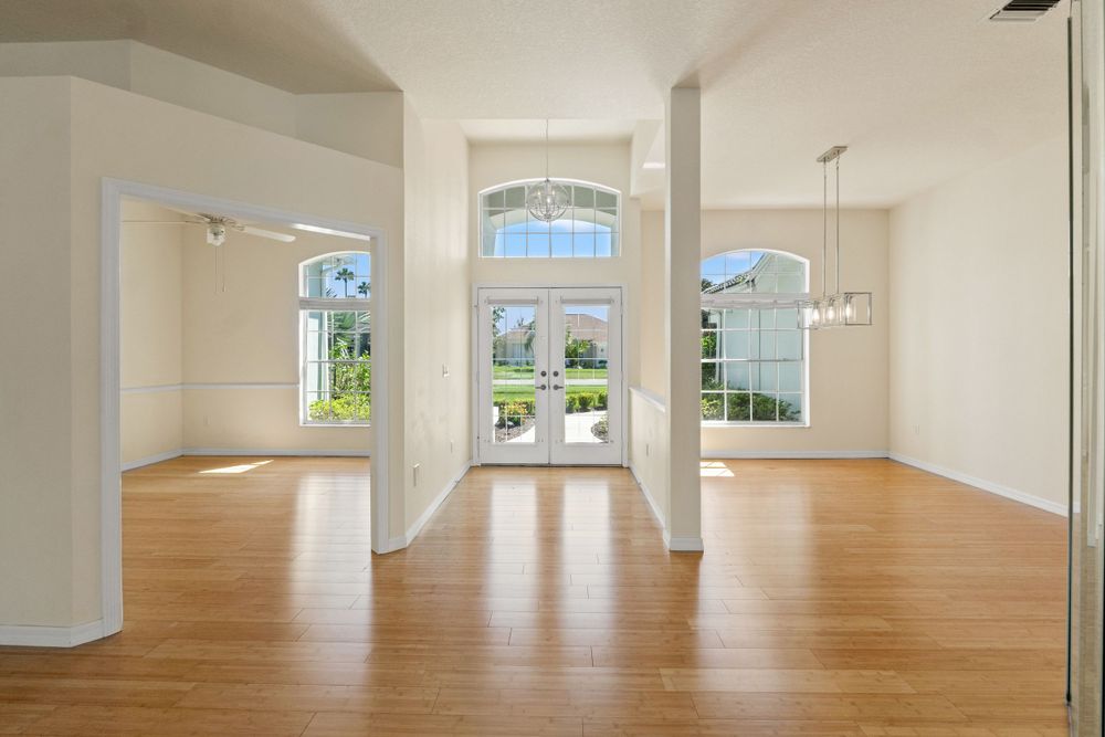 Open concept interior space with hardwood floors and large windows.