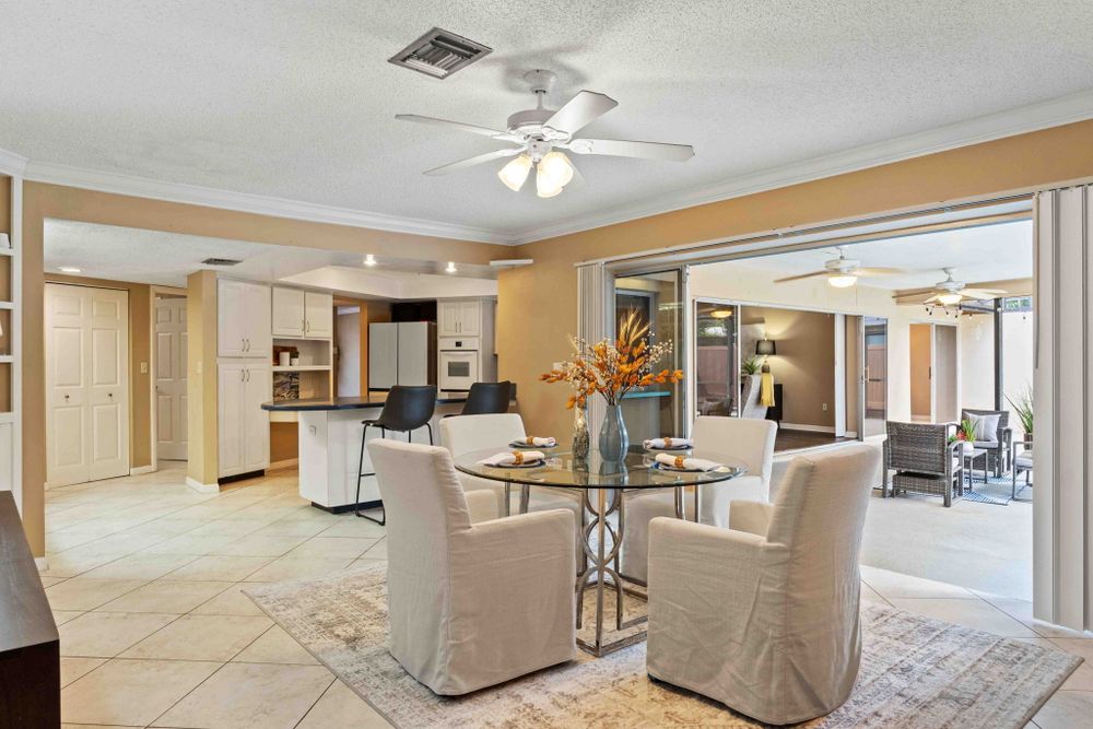 Large open floor plan interior with white walls and multiple seating areas.