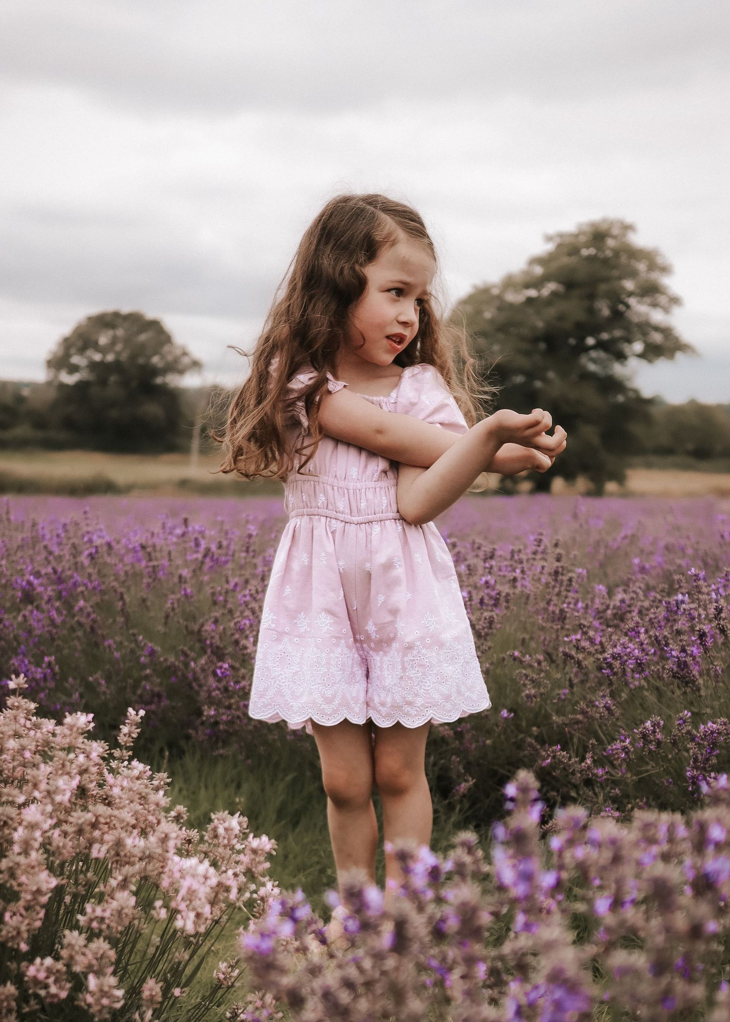 A pink dress twirling through a beautiful purple lavender field.