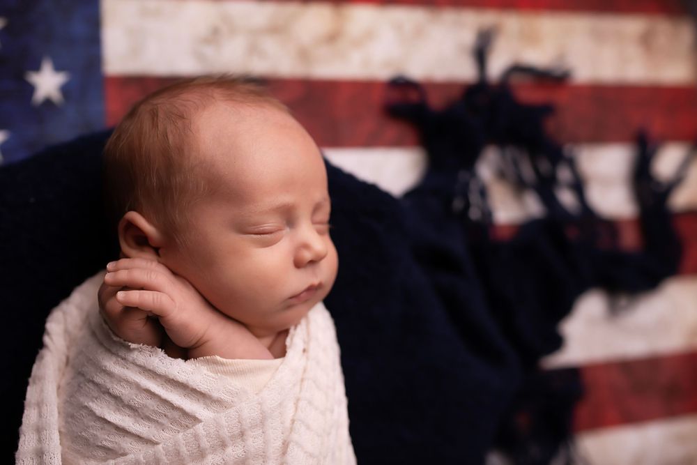 A collage of newborn baby photos featuring patriotic American flag backdrop in each shot.