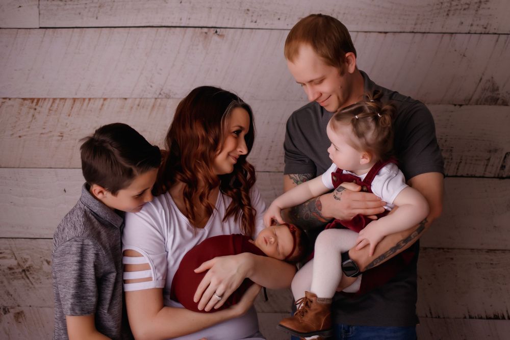 Heartwarming series of intimate black and white family moments showing parents hugging and bonding with their children.