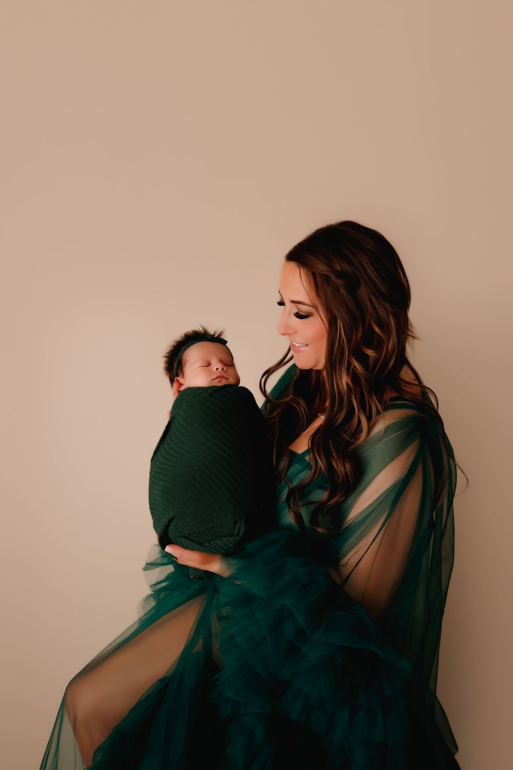 A tender series of photos showing an emotional embrace between two people against a neutral backdrop.