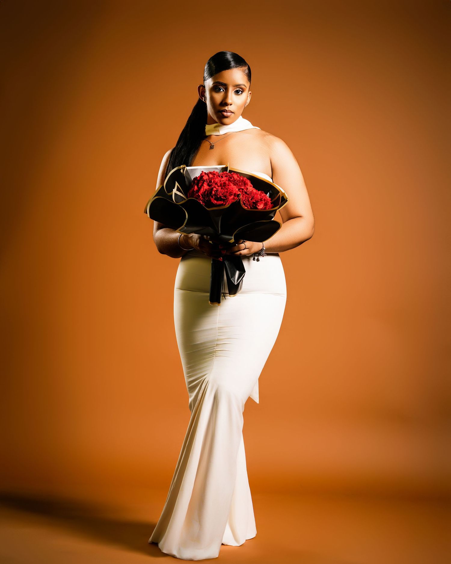 studio session captured by Timoy B Photography – elegant portrait on warm backdrop.