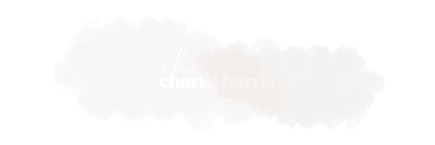 A light gray watercolor brush stroke with 'charles harris' text overlay on black background.