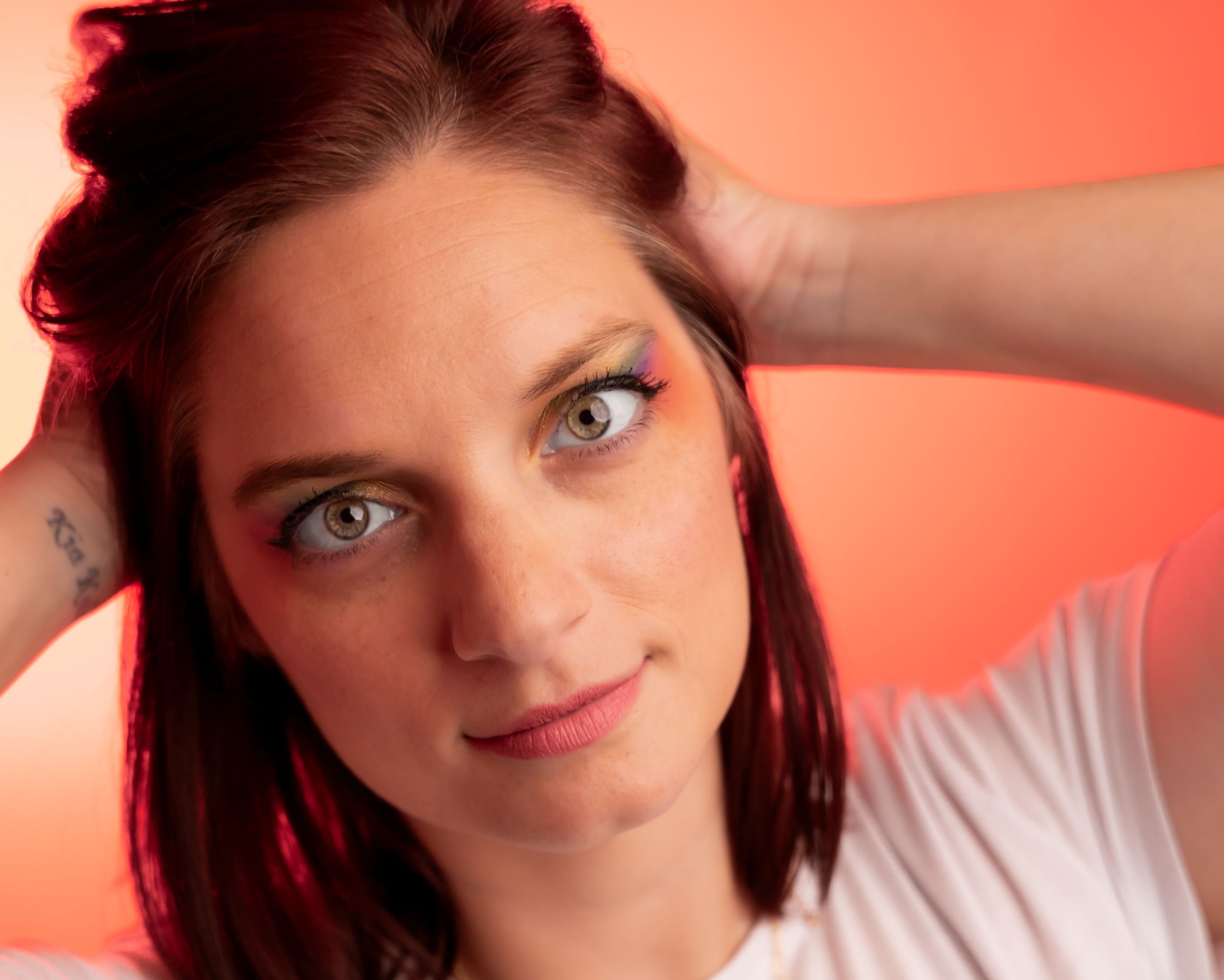 Portrait shots with red lighting and expressive poses in a white shirt.