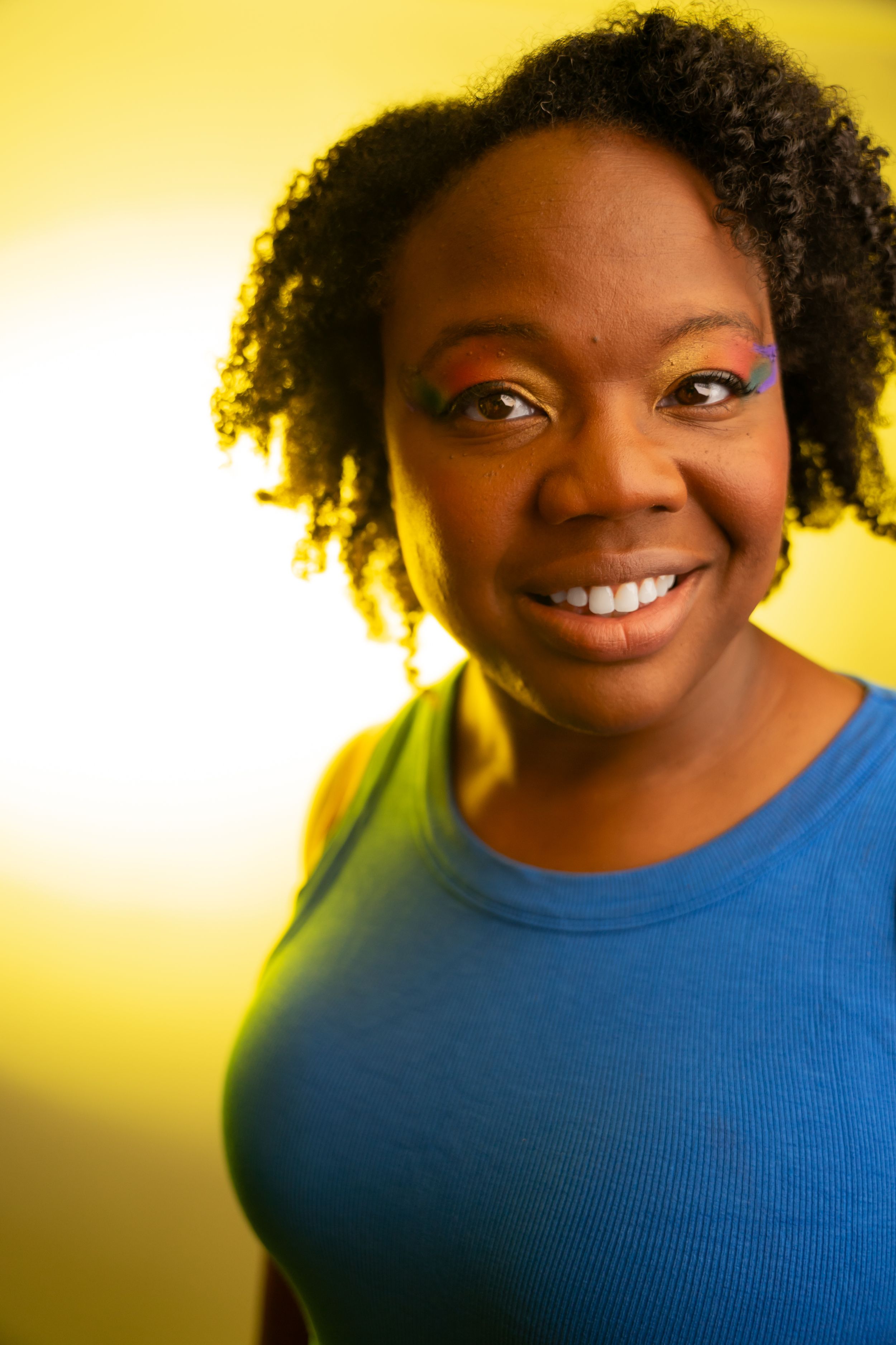Portrait series with natural expressions against a vibrant yellow backdrop.