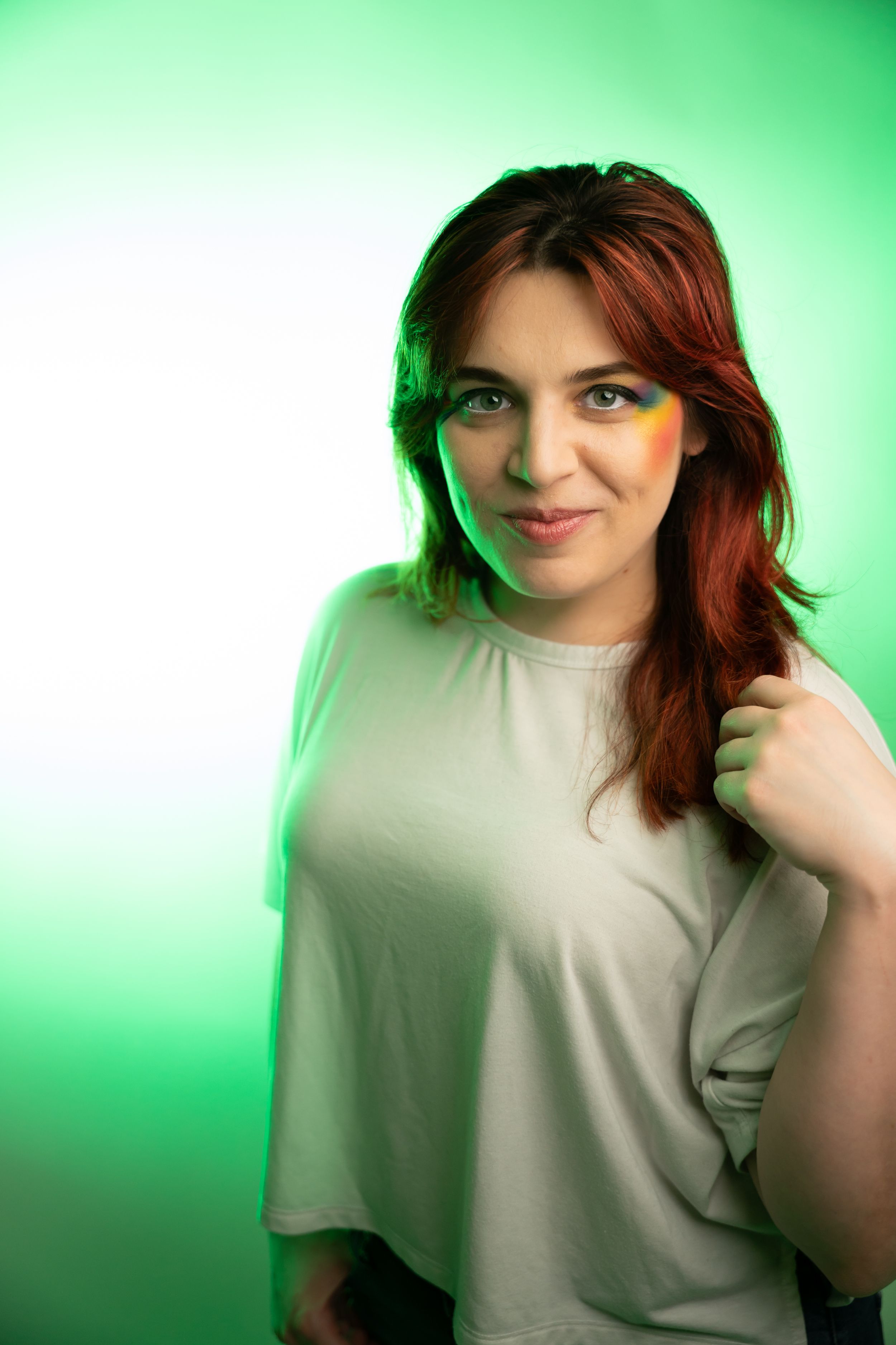 Studio portraits with soft lighting against a green gradient backdrop.