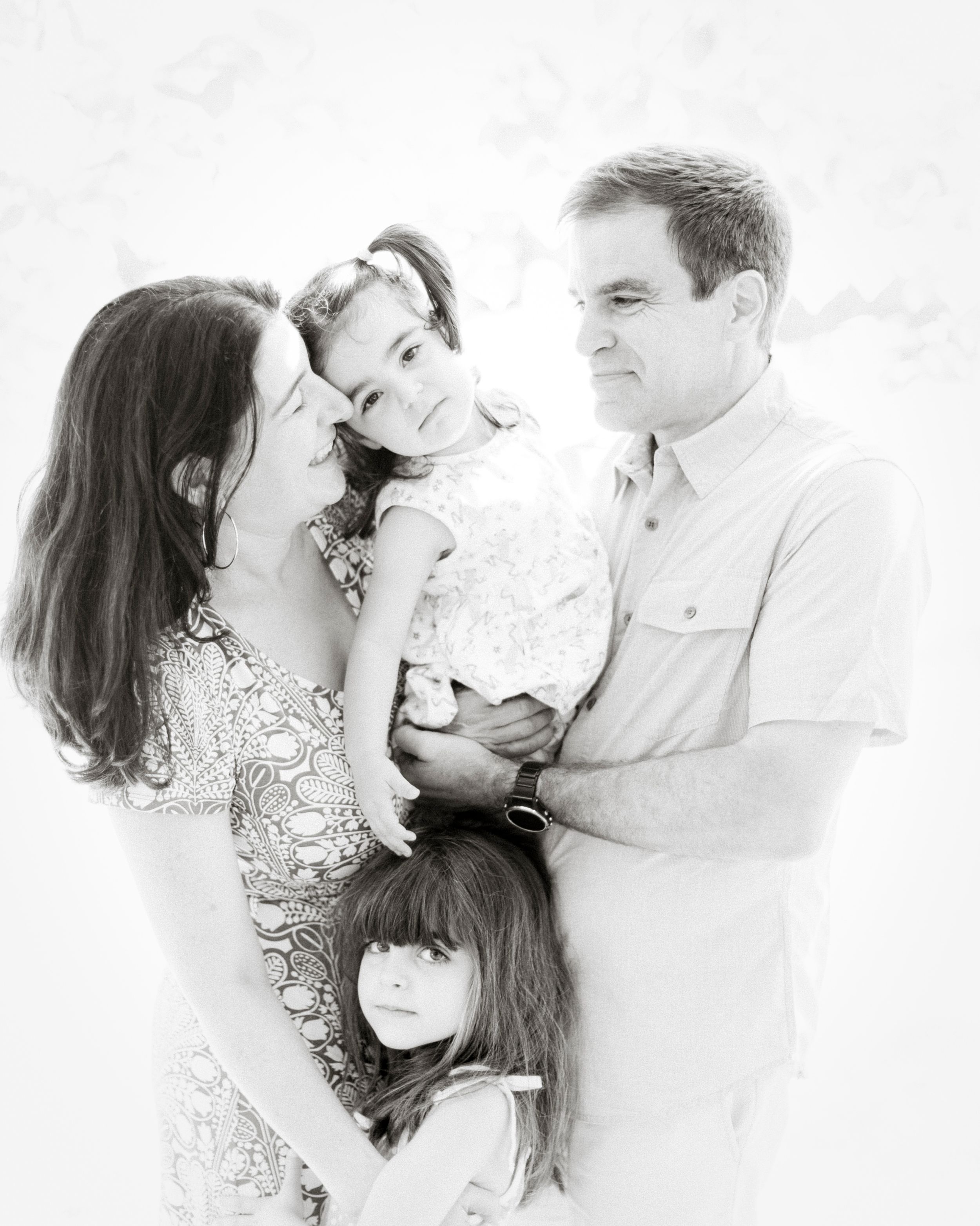 A classic black and white family portrait showing tender embraces and loving connections.