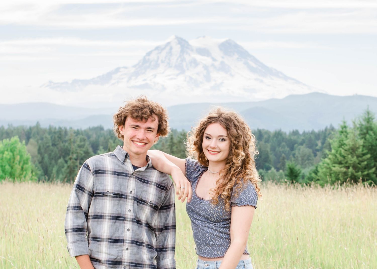 Scenic mountain landscape portrait with snow-capped peaks in background.