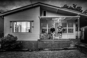 Exterior panoramic view of a suburban house in dramatic black and white.