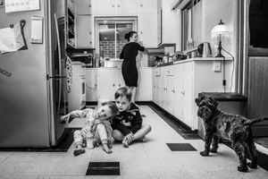 Series of black and white photos showing movement through a hallway with a dog.
