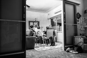Black and white sequence showing activity in a home hallway or corridor.