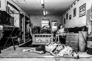 Black and white panoramic sequence showing dogs relaxing in an indoor space.