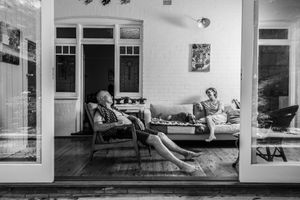 Black and white panoramic sequence showing a modern interior living space.