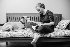 Black and white photo series showing a person relaxing on a floral patterned couch.