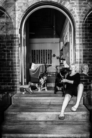 Black and white sequence showing a dog and feet on a brick porch with arched doorways.