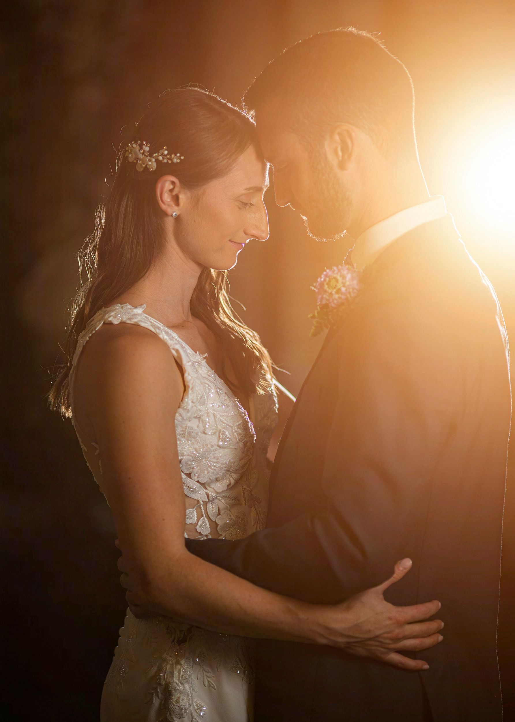 Mansion Inn of Saratoga in Saratoga Springs NY wedding venue. Bride and groom backlit.