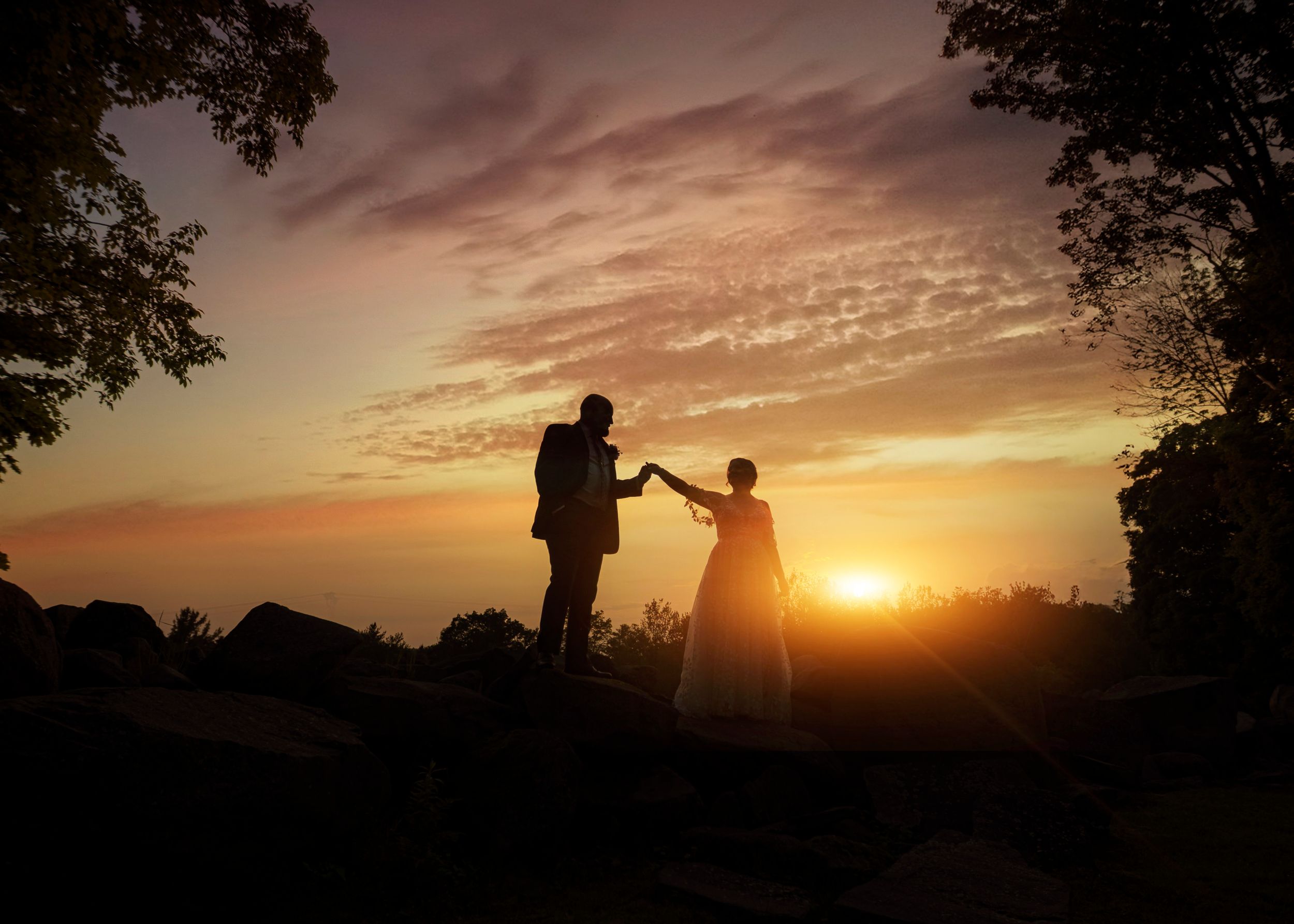 Greywacke Meadows, Cropseyville NY wedding venue. Bride and groom silhouette on rocks during sunset.