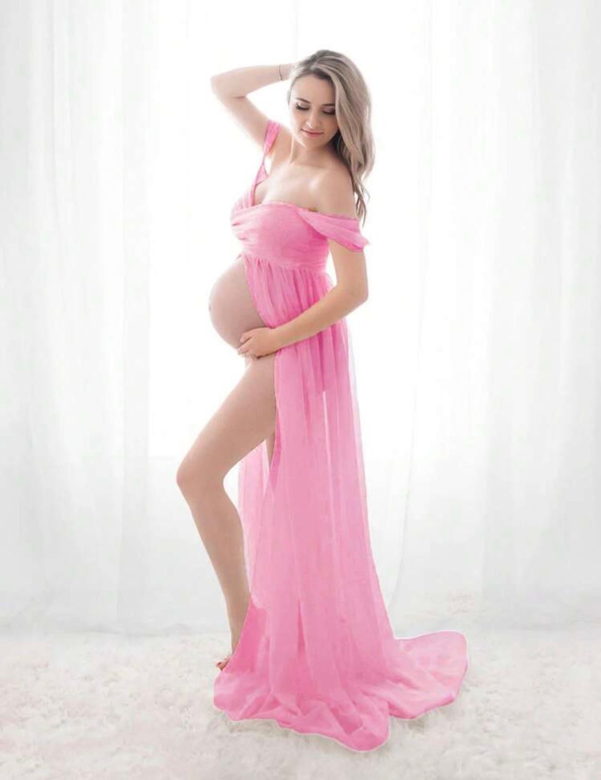 Artistic maternity photo sequence showing woman in flowing pink dress against white backdrop.