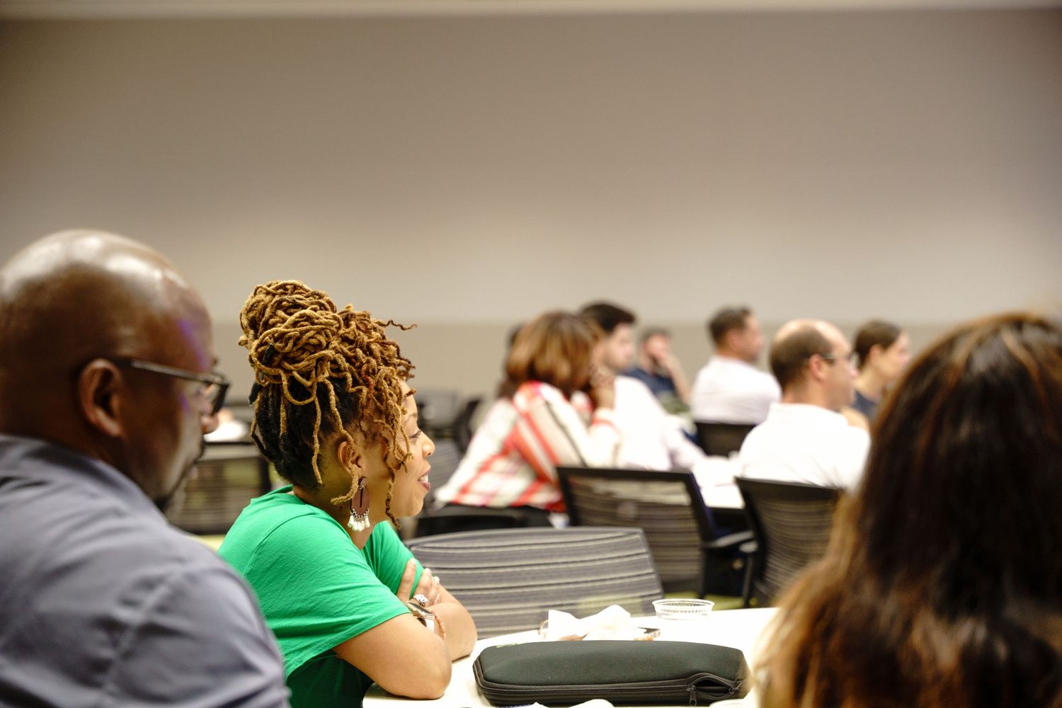Audience members seated in rows at a professional conference or seminar.