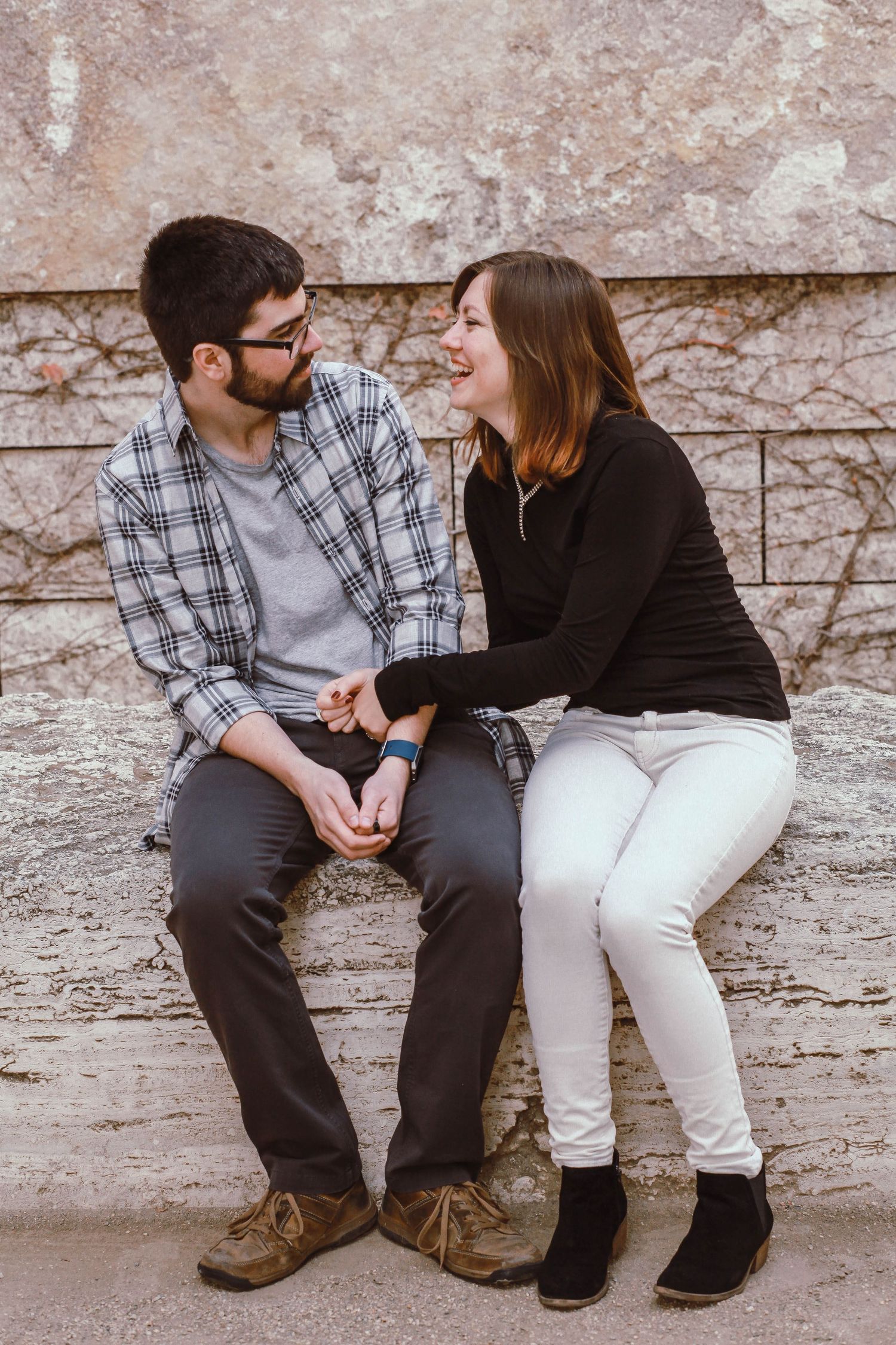 A man and woman face each other and laugh at The Getty Museum in Los Angeles.