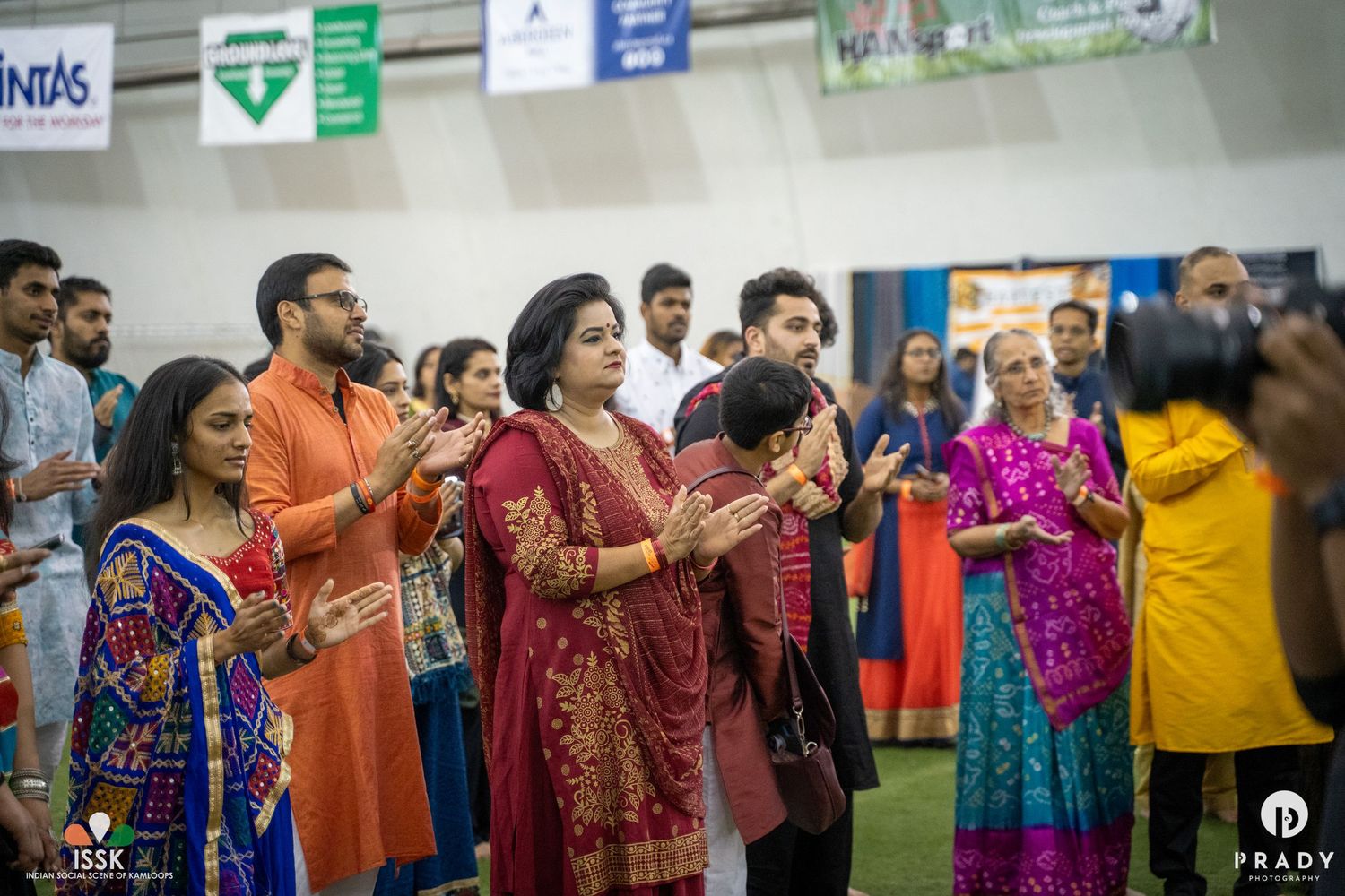 A group of celebrants in colorful traditional Indian clothing participating in a cultural ceremony.