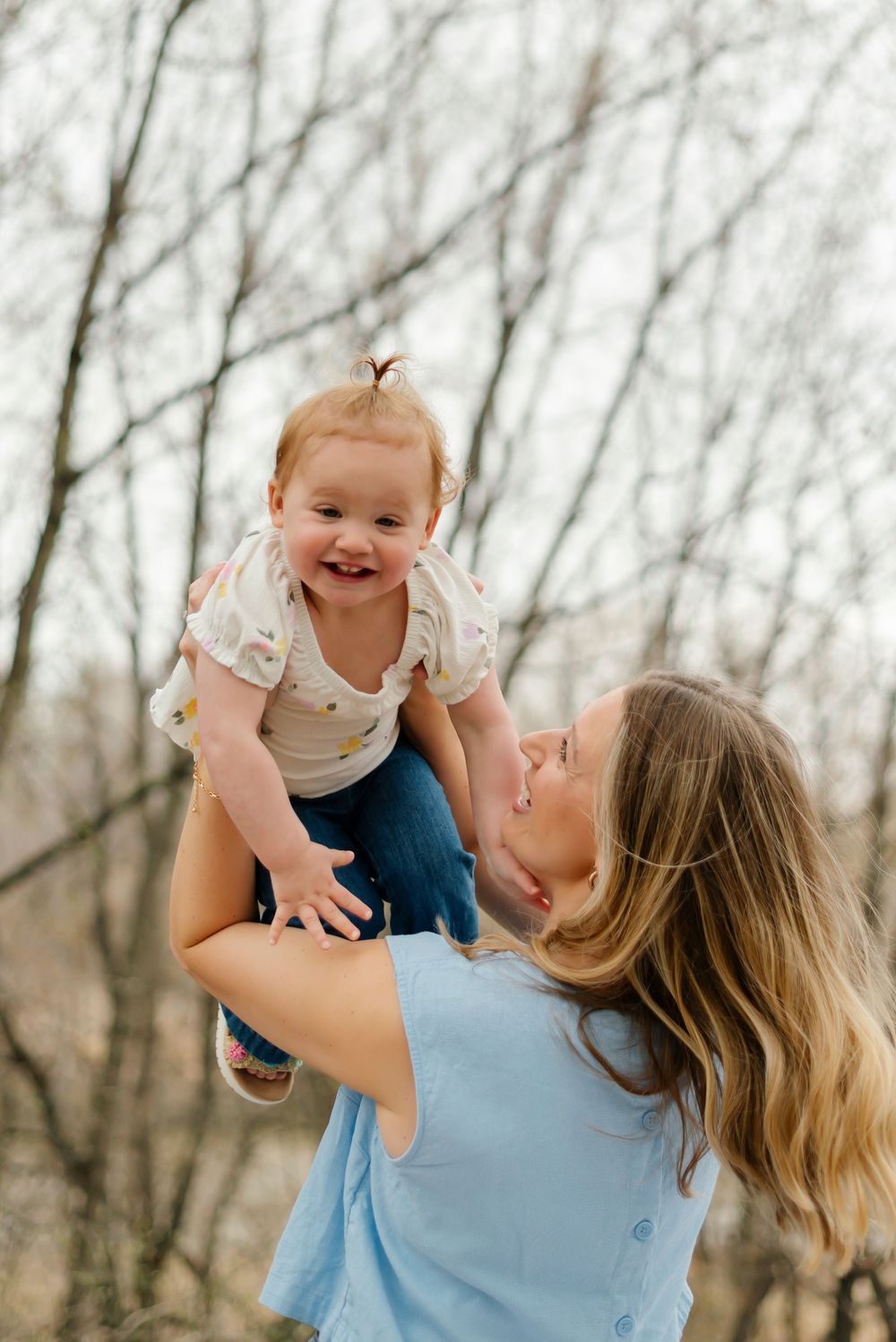 Joyful outdoor photo sequence showing playful interaction between parent and baby against bare winter trees.