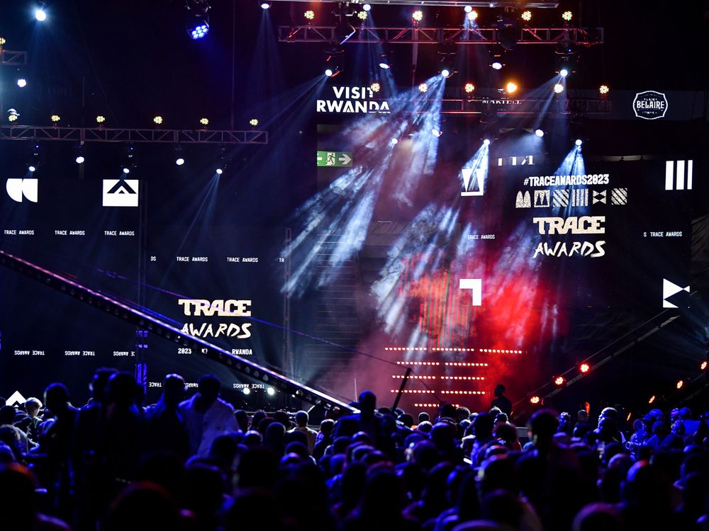 Concert venue with large screens displaying Trace Awards graphics and colorful stage lighting.
