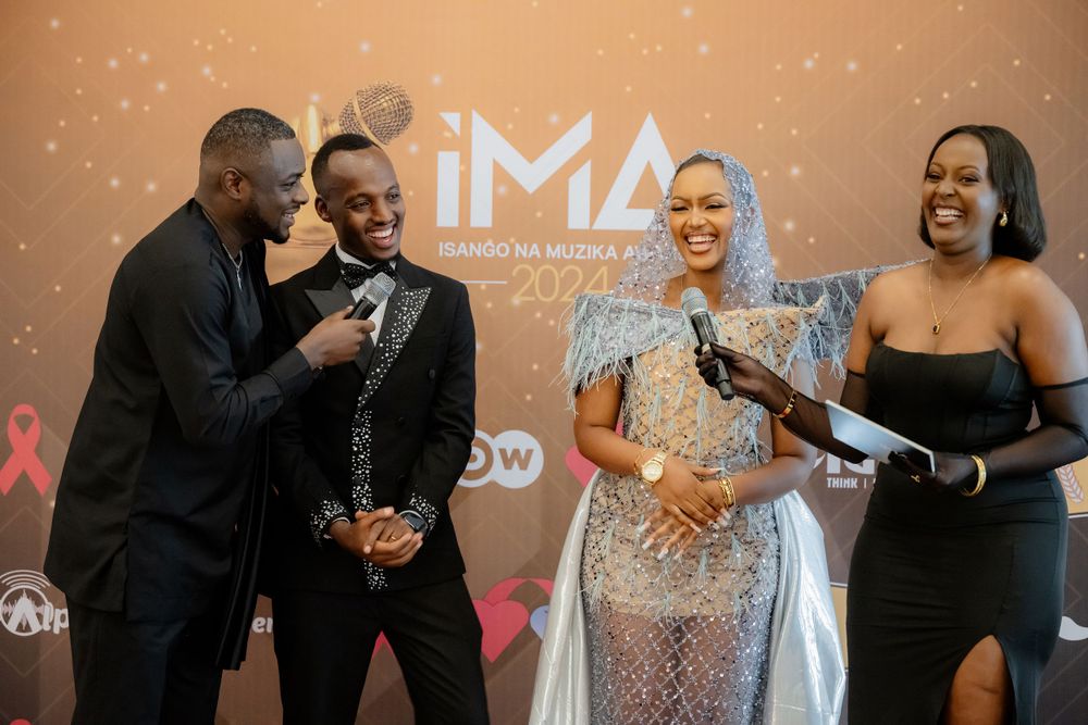 Group of performers share a candid laughing moment at the IMA 2024 Awards ceremony.