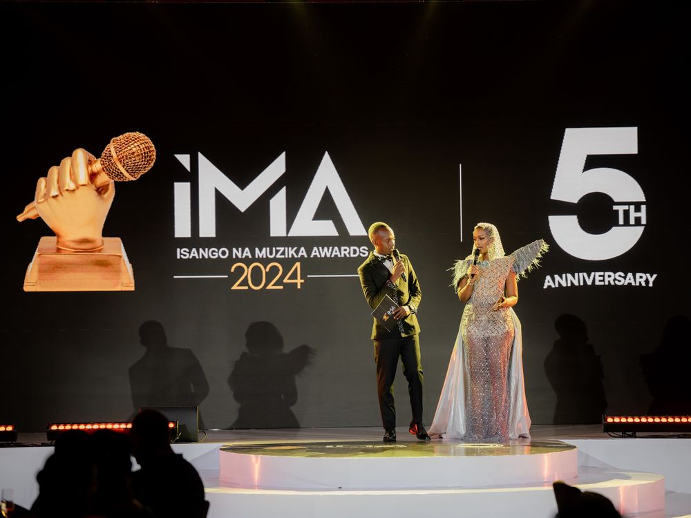 Two performers on stage during the IMA 5th Anniversary celebration.