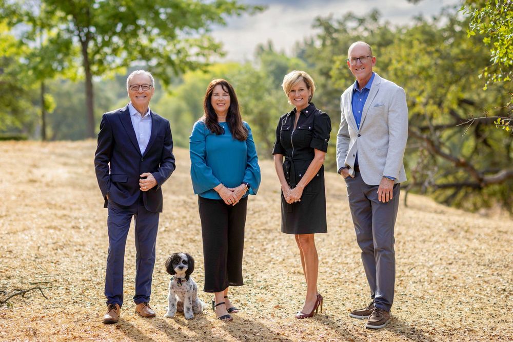 Group walking together on a gravel path outdoors with trees and natural scenery in the background.