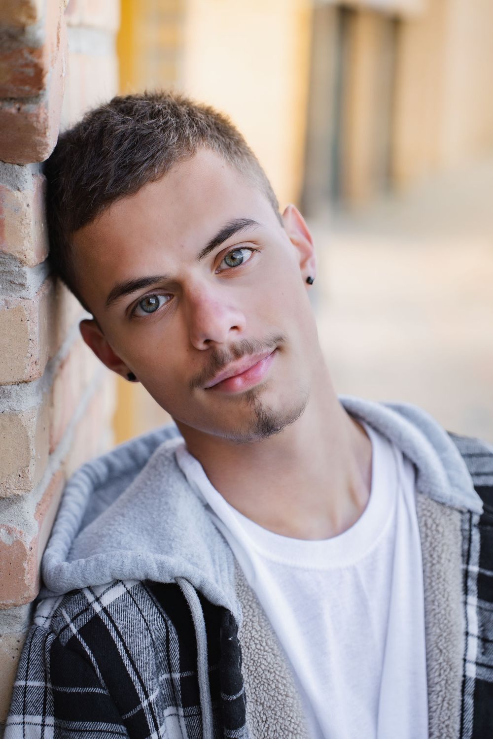 A series of close-up portrait photos showing different facial expressions against a light colored wall.