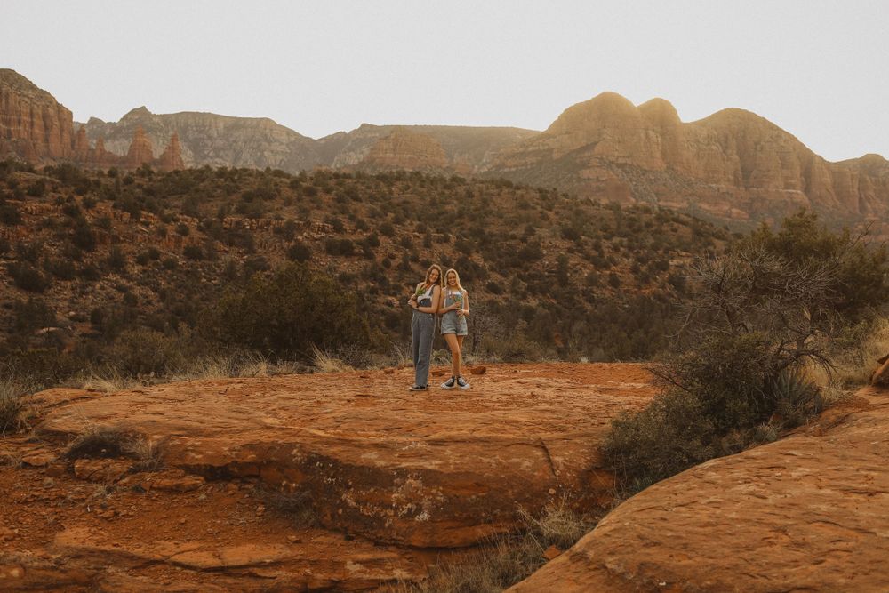 Red rock formations and desert landscape under bright sunlight.