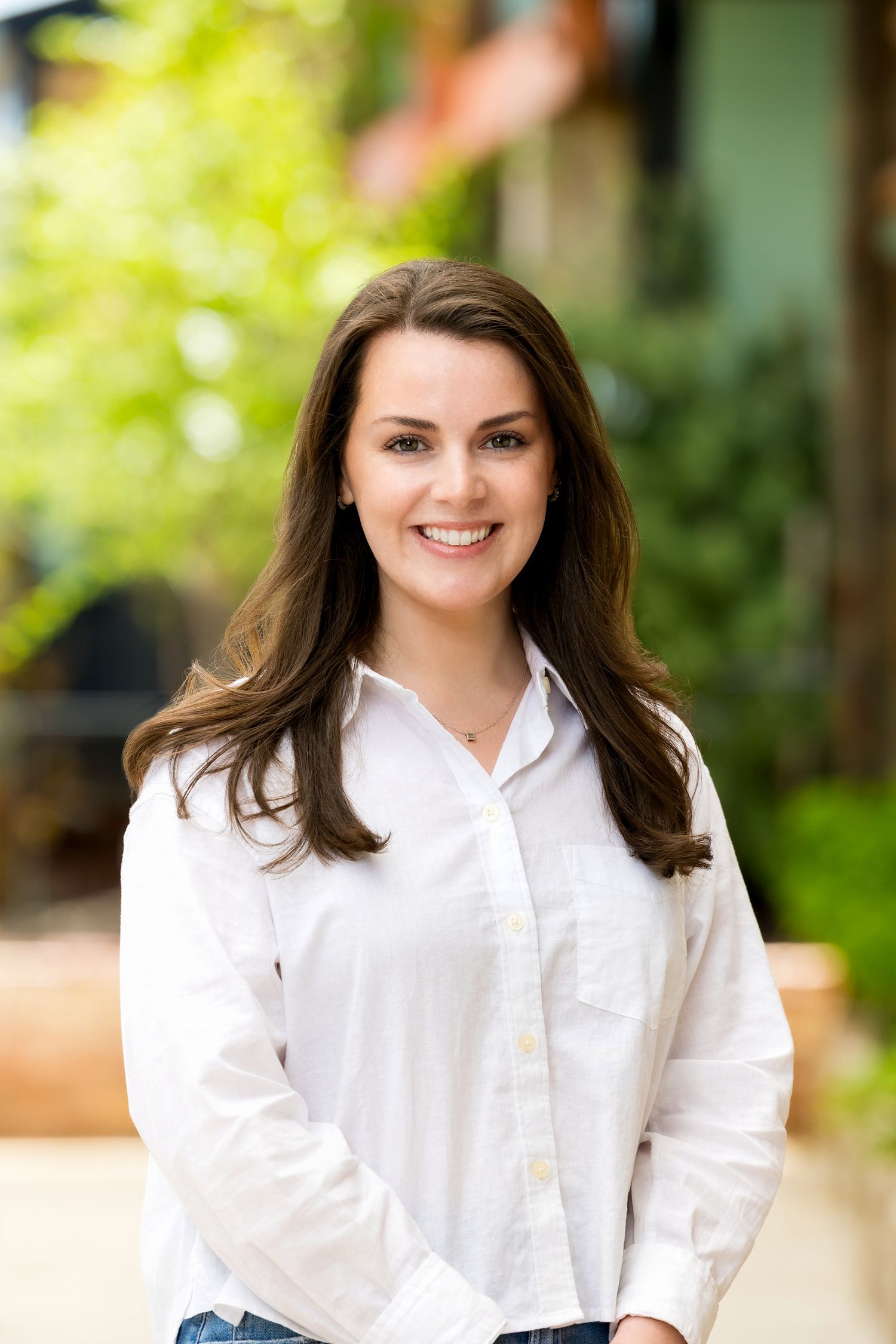 Professional portraits of a person in a crisp white button-down shirt against a natural background.