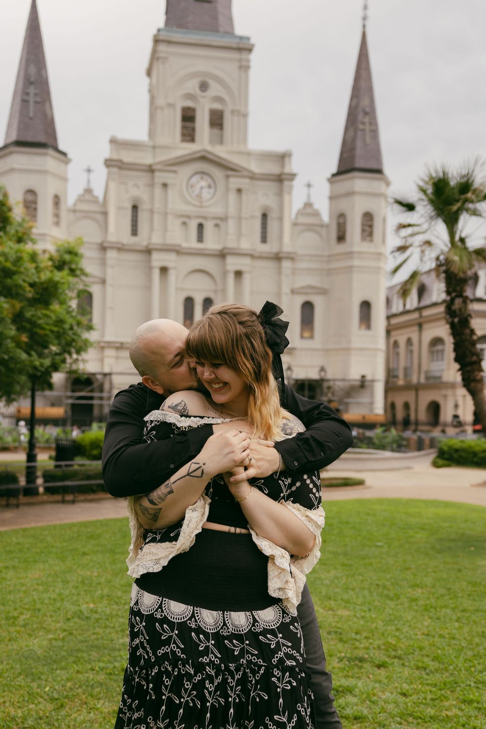 A romantic moment shared between a couple in front of St. Louis Cathedral in New Orleans' Jackson Square.