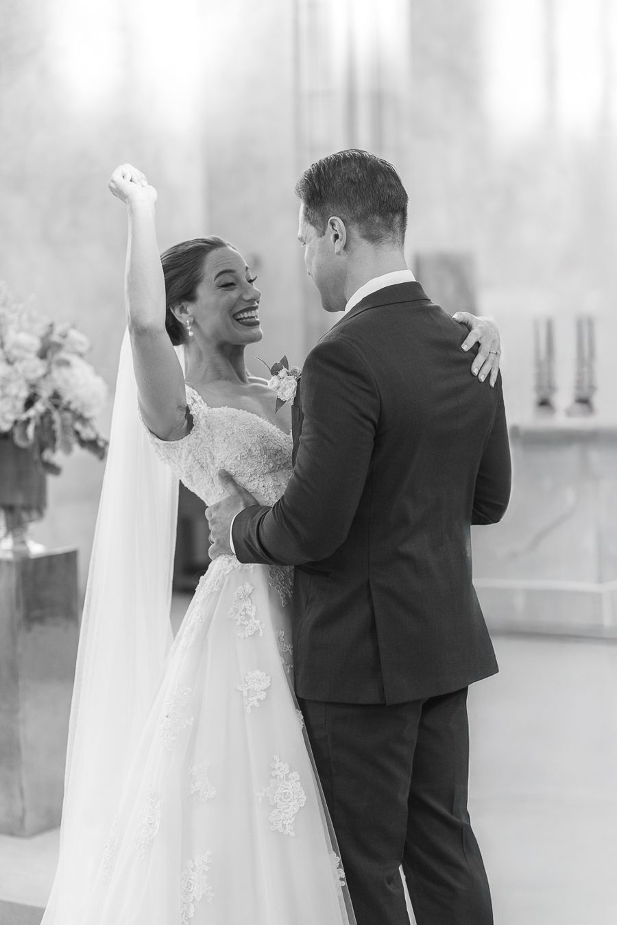 Bride raising her hand in celebration at a wedding