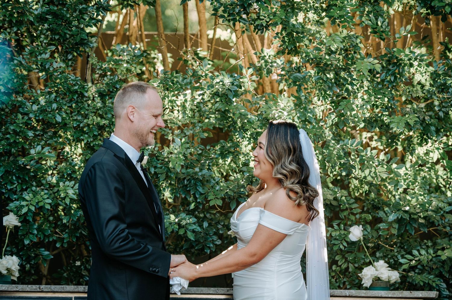 Elegant outdoor wedding ceremony with twinkling lights and greenery creating a romantic atmosphere.