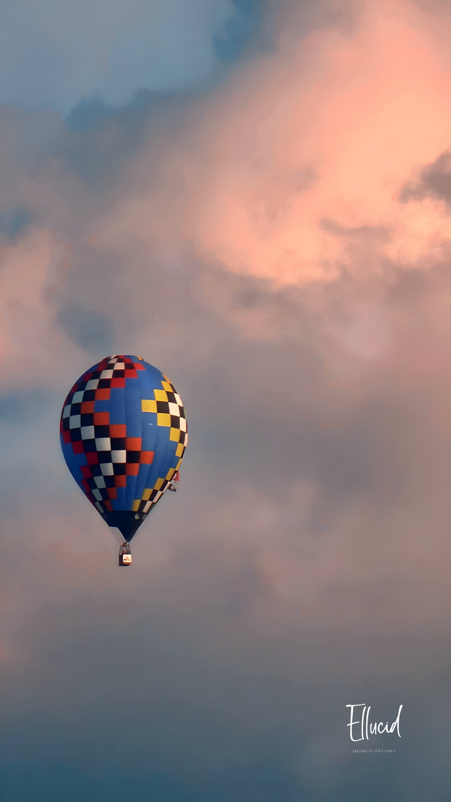 Colorful hot air balloon floating in pink and purple sunset sky.