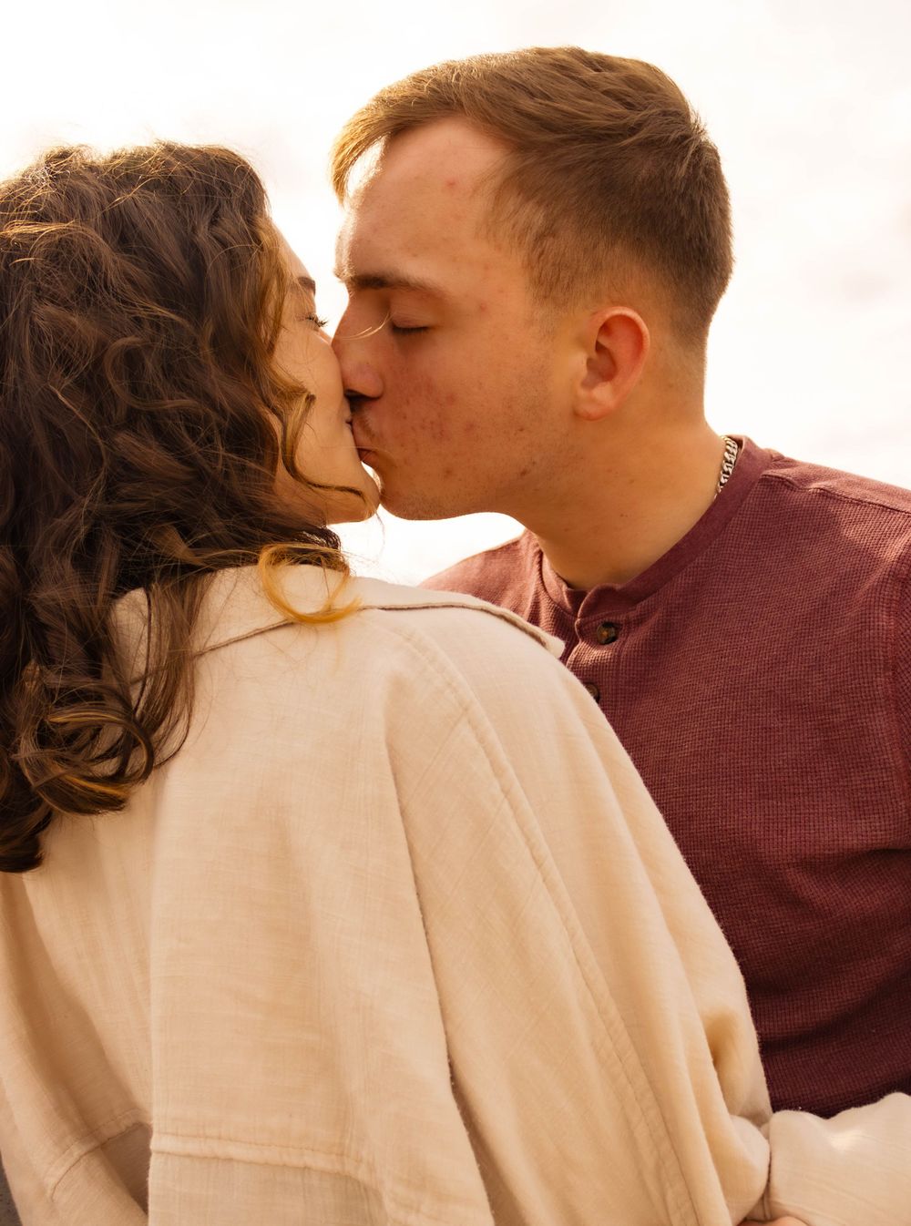 Intimate sunset portrait of couple sharing romantic moment.