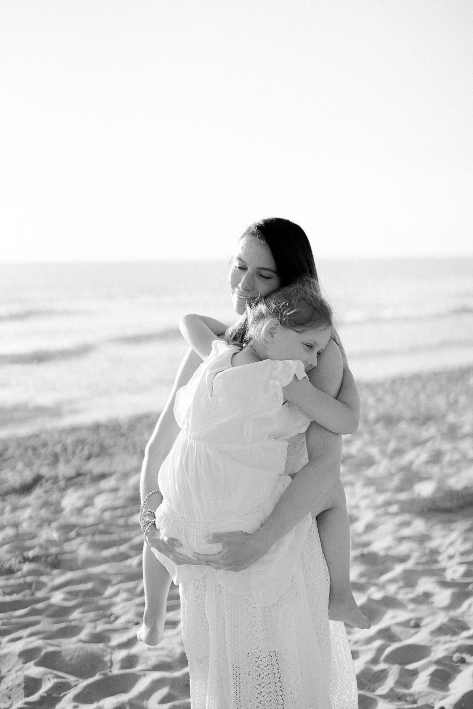 daughter hugs mother in Versilia beach during summer vacation