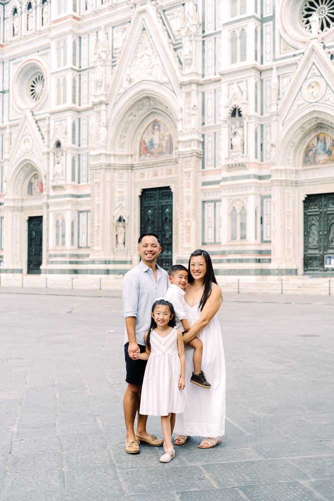 parents and children hugging in florence historic piazza del duomo