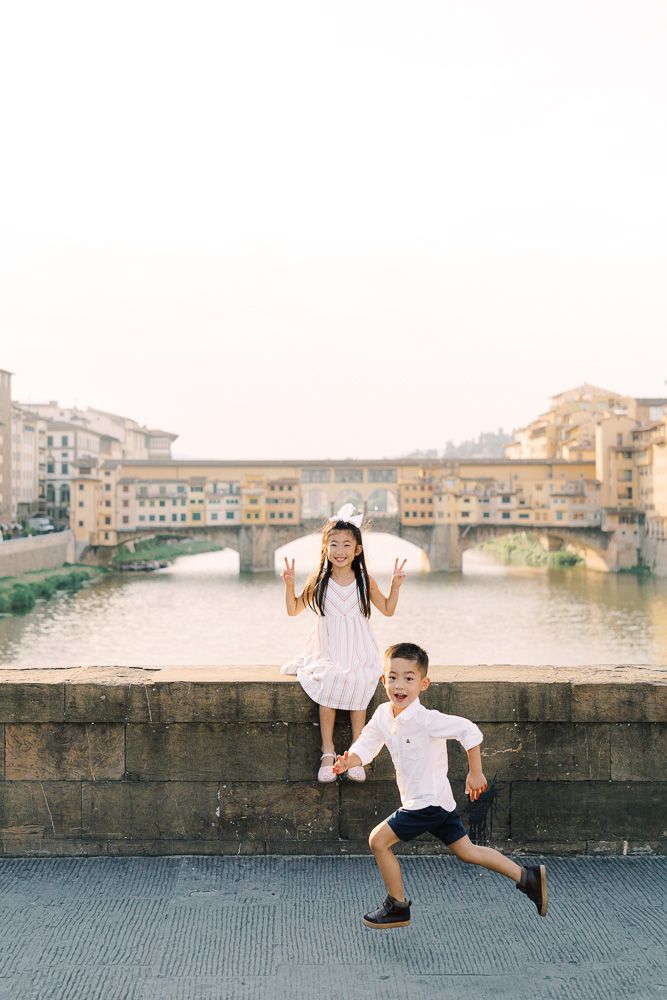 children playing near Ponte Vecchio in Florence during summer vacation