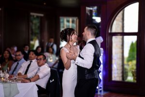 A couple shares an intimate dance moment during their wedding reception.