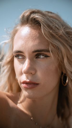 Summer beauty portrait with natural makeup and golden lighting.