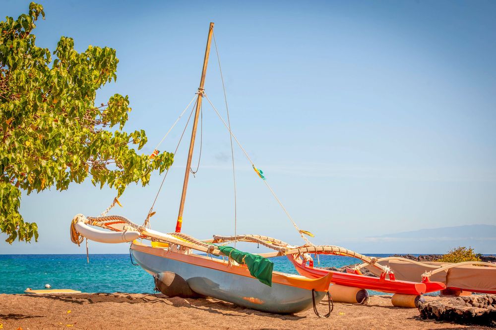 boat resting on the beach in the Kona Village Resort on the Big Island of Hawaii in the sun