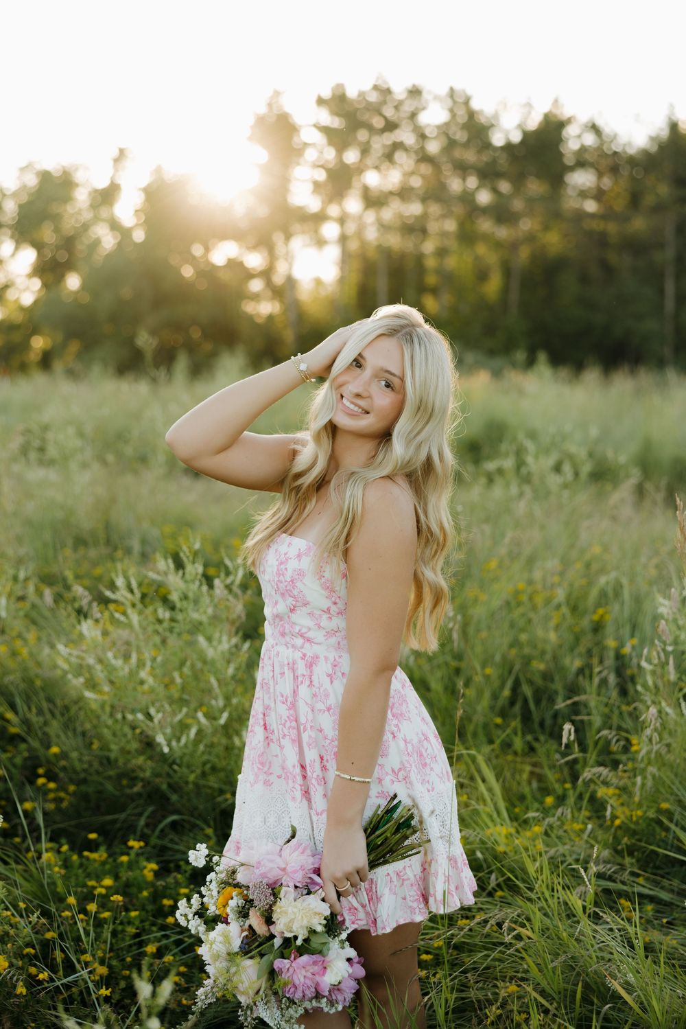 A dreamy summer photoshoot in a wildflower meadow at golden hour featuring floral fashion and natural lighting.