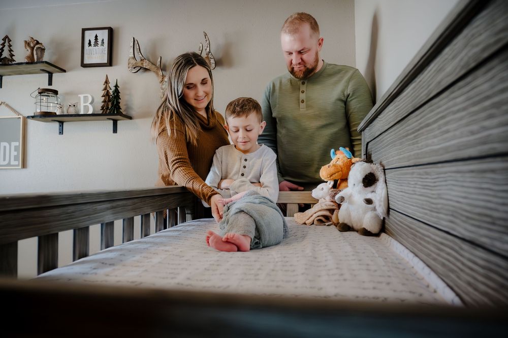 Family playing together on bed in cozy bedroom setting.
