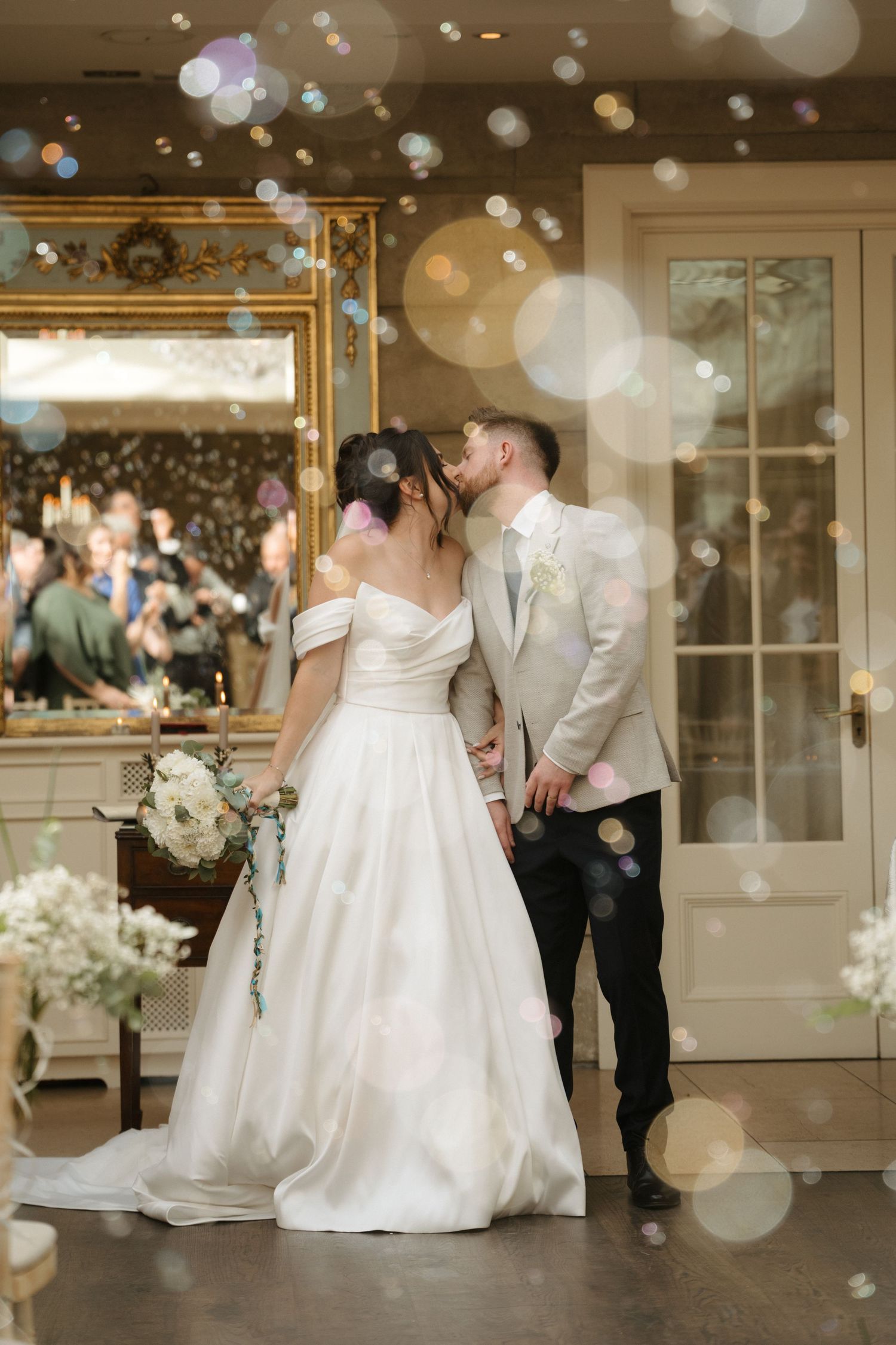 A wedding celebration in an elegant indoor venue with dreamy bokeh light effects.