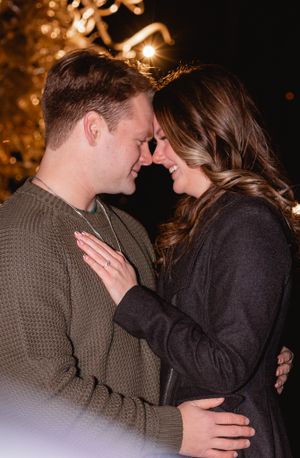 Intimate close-up of couple sharing tender moment under warm evening lights.