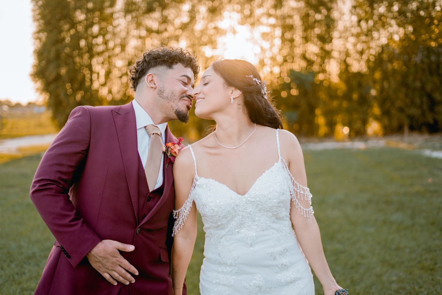 intimate romantic wedding photo of a couple walking through the woods down a gravel road on their wedding day